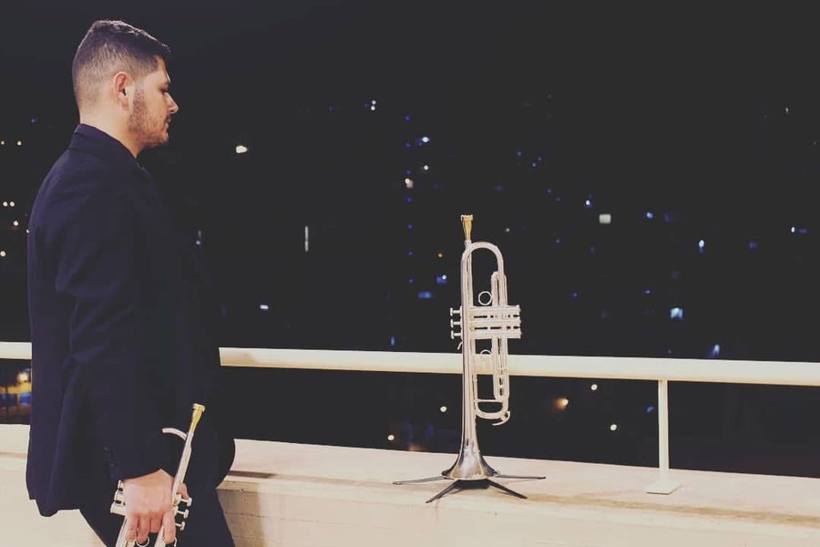 Sebastián en un balcón de noche junto a su trompeta